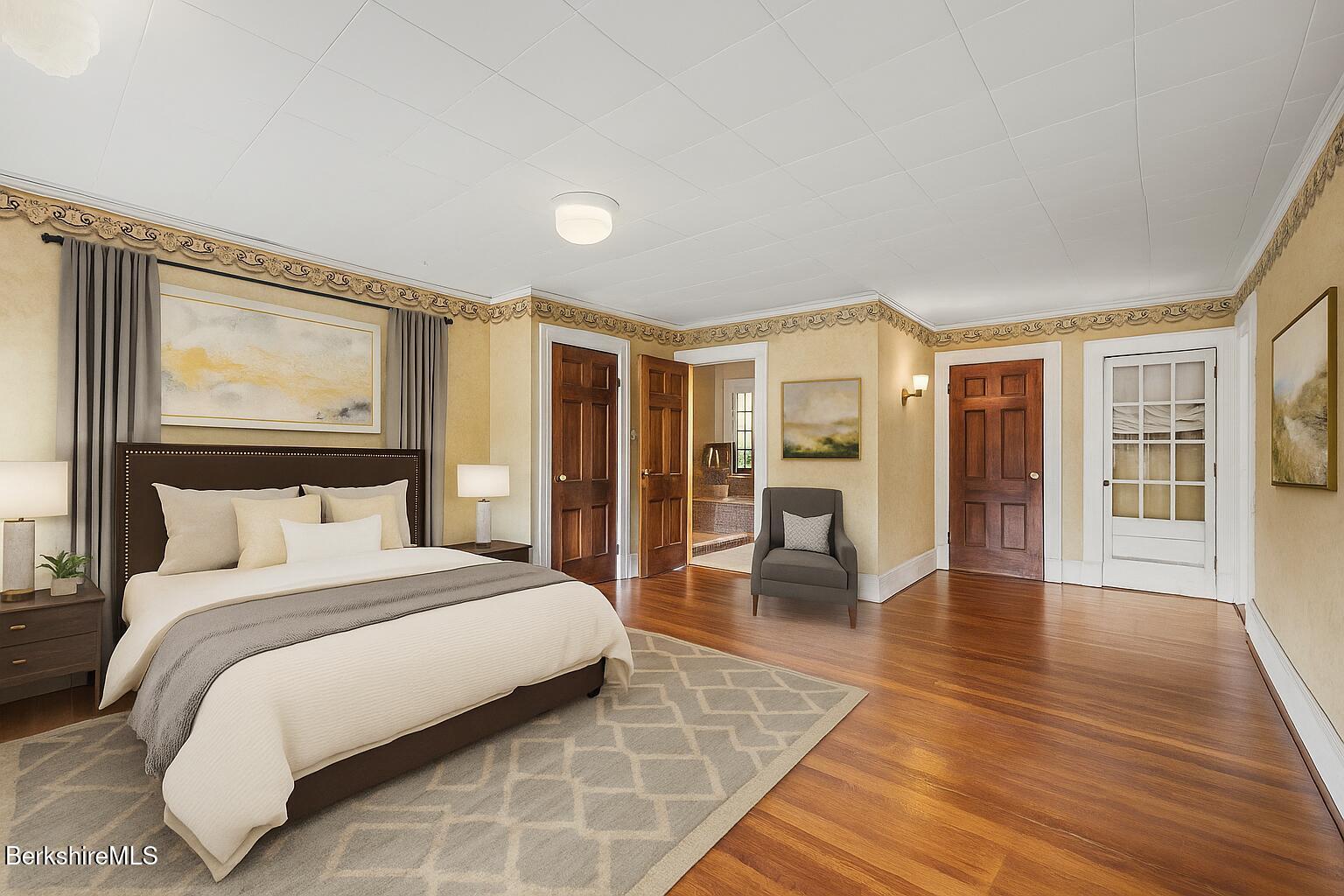 5 Crofut Street Pittsfield, MA 01201 - Photo 28 of 63 a bedroom with a large bed and a wooden floor