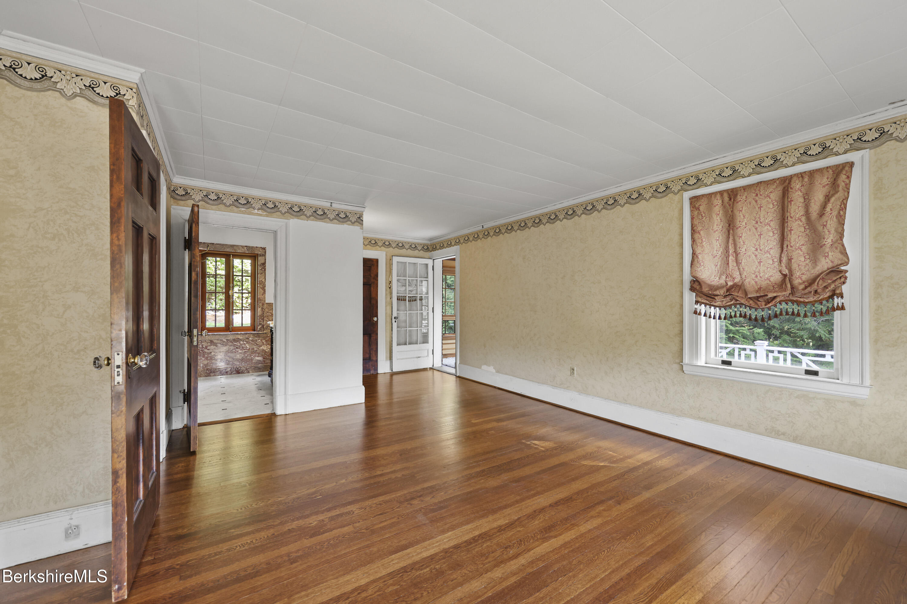 5 Crofut Street Pittsfield, MA 01201 - Photo 29 of 63 a view of an empty room with wooden floor and a window