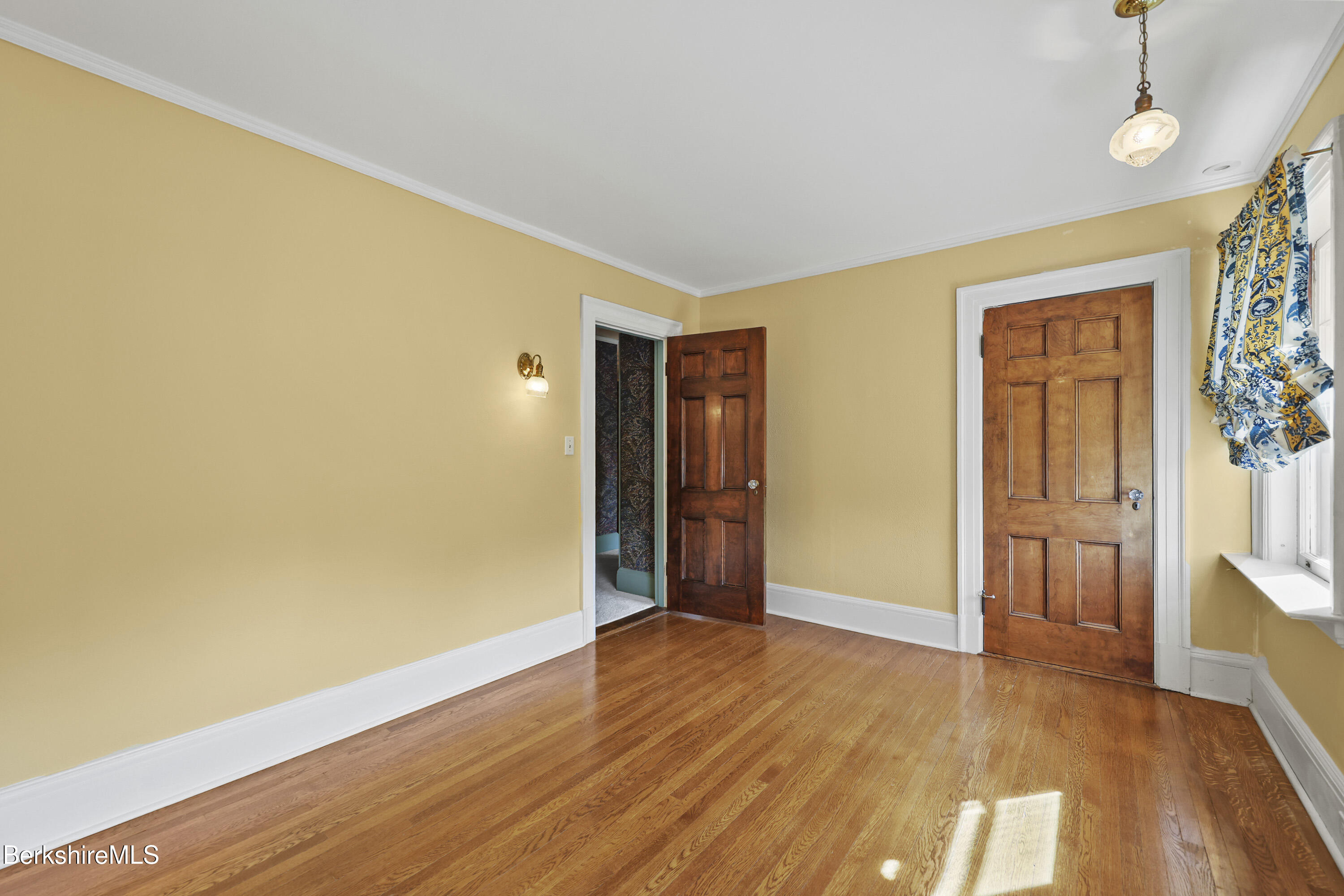 5 Crofut Street Pittsfield, MA 01201 - Photo 40 of 63 a view of an empty room with wooden floor and a window
