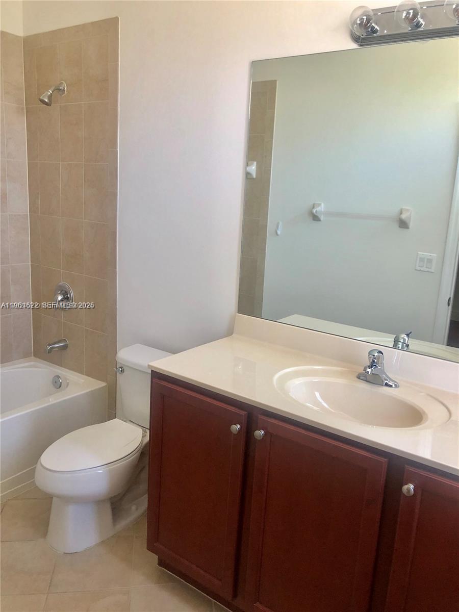9041 Southwest 227th Street, Unit 5 Cutler Bay, FL 33190 - Photo 14 of 27 a bathroom with a sink a toilet and shower