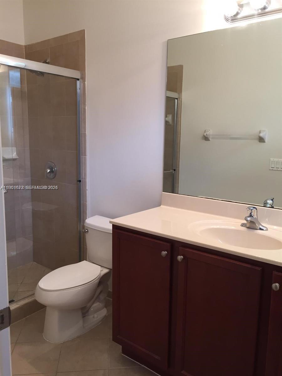 9041 Southwest 227th Street, Unit 5 Cutler Bay, FL 33190 - Photo 22 of 27 a bathroom with a sink toilet and shower