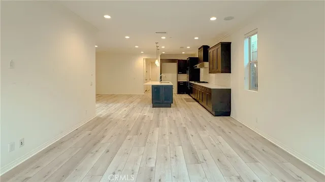 a view of kitchen with cabinets and wooden floor