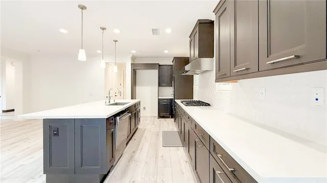 a kitchen with a sink and a stove top oven