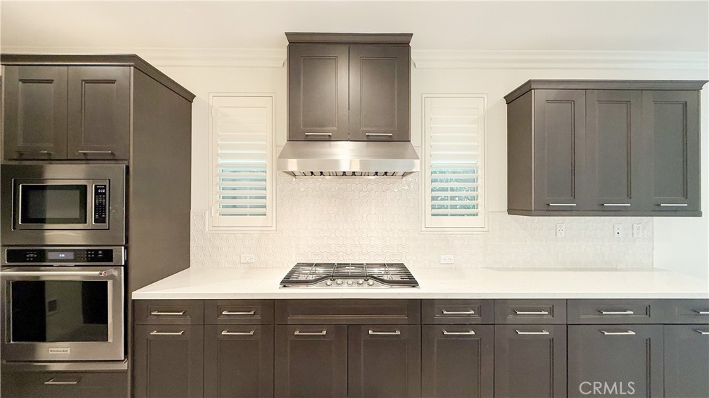 140 Hemisphere Irvine, CA 92618 - Photo 12 of 46 a kitchen with granite countertop a stove and a microwave