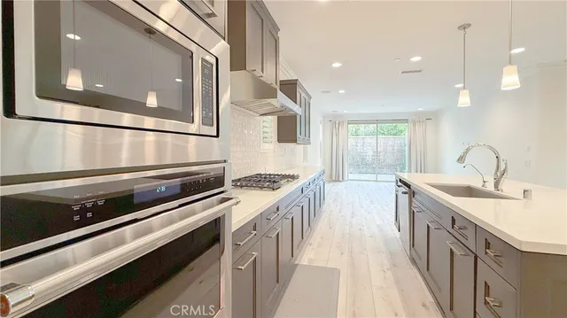 a kitchen with sink stove and cabinets