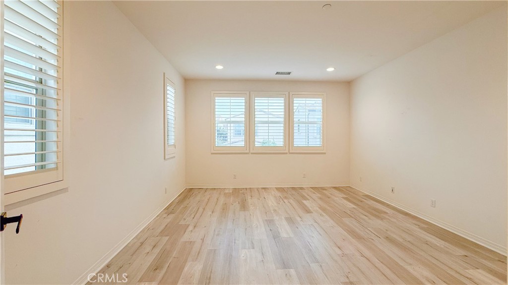 140 Hemisphere Irvine, CA 92618 - Photo 17 of 46 an empty room with wooden floor and windows