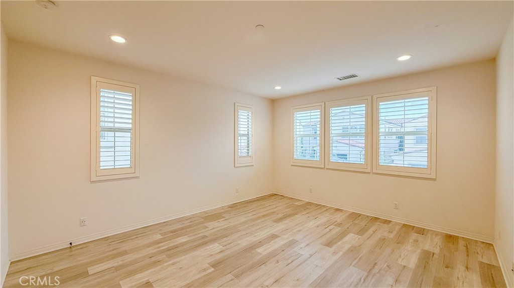 140 Hemisphere Irvine, CA 92618 - Photo 18 of 46 a view of an empty room with wooden floor and a window