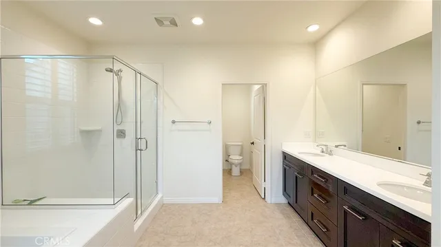 a spacious bathroom with a shower and a sink