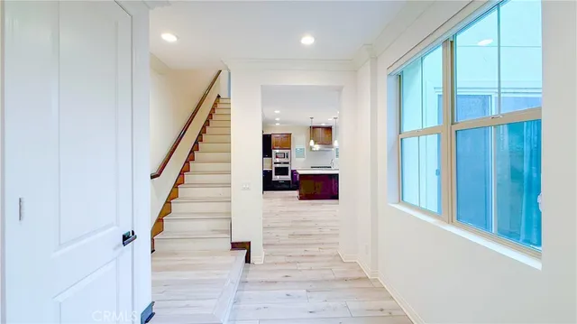 a view of a hallway with wooden floor and entryway