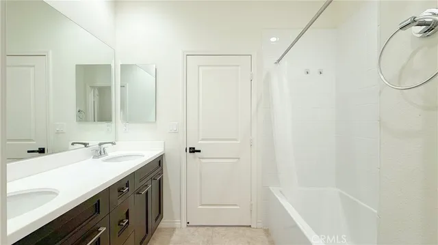 a bathroom with a tub sink and mirror