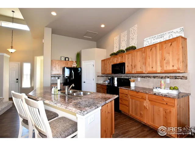a kitchen with stainless steel appliances kitchen island granite countertop a sink and cabinets