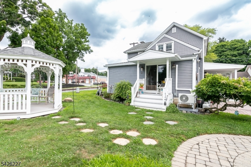 36 Main Street Flanders, NJ 07836 - Photo 35 of 49 a front view of a house with a yard table and chairs