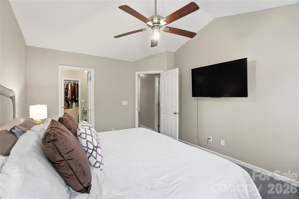 a bedroom with a large bed and a flat screen tv