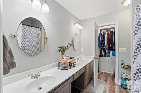 a bathroom with a sink vanity and mirror