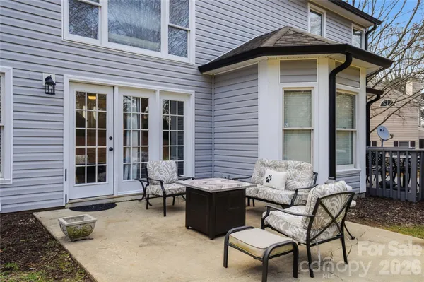 a backyard of a house with table and chairs