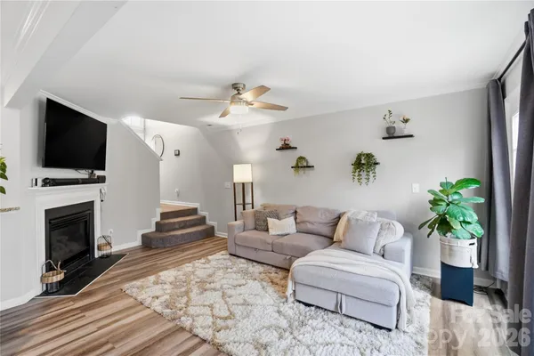 a living room with fireplace furniture and a flat screen tv
