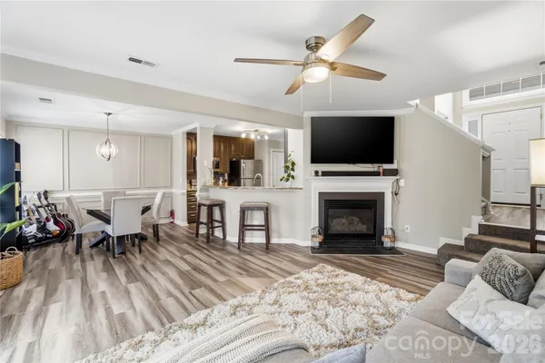a living room with furniture a fireplace and a flat screen tv
