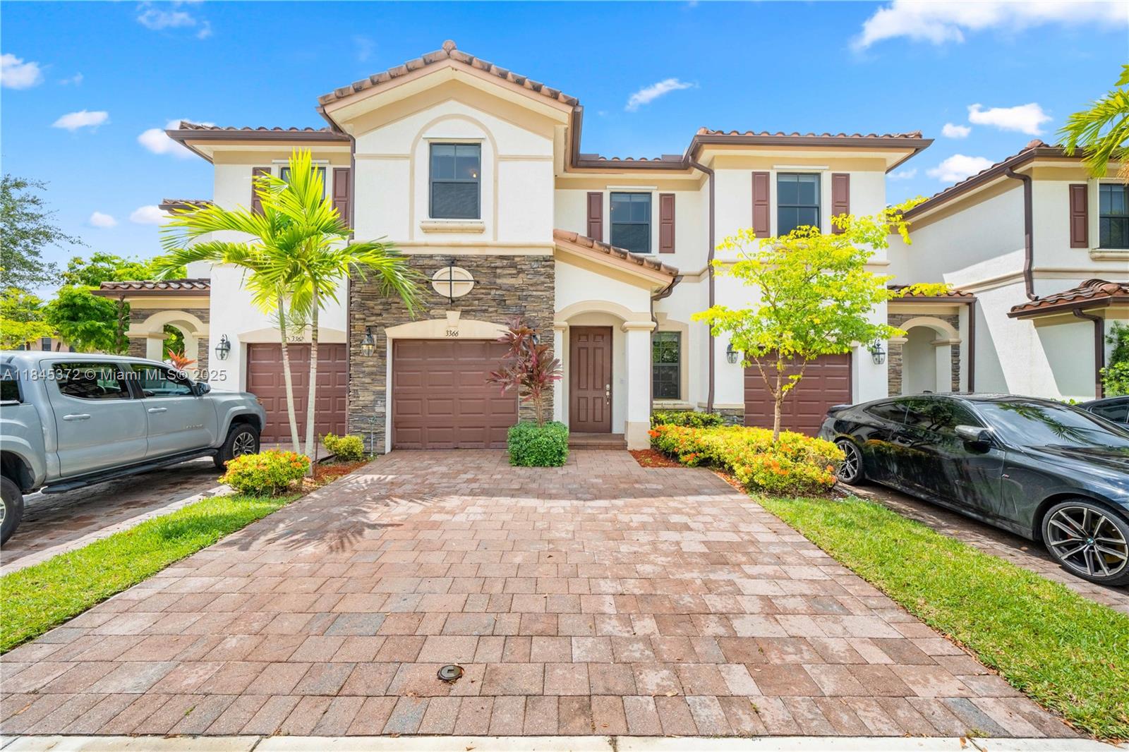3366 West 90th Terrace, Unit 3366 Hialeah, FL 33018 - Photo 1 of 26 a front view of a house with a yard and outdoor seating