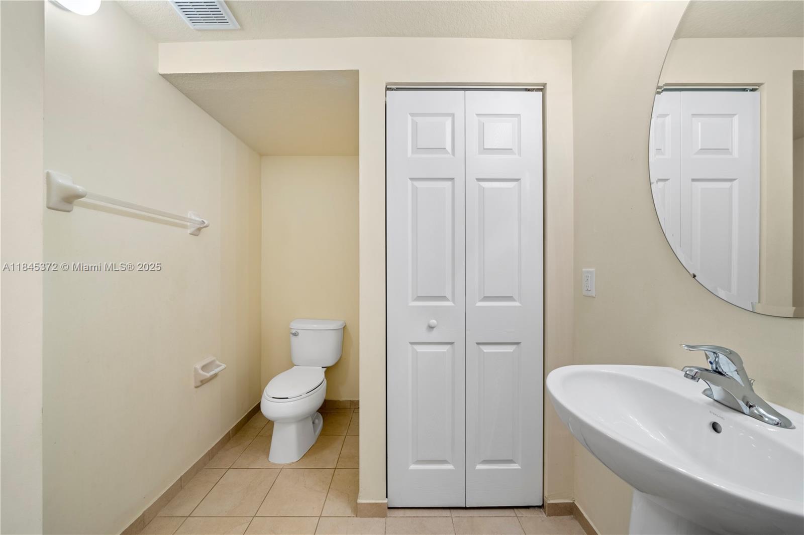 3366 West 90th Terrace, Unit 3366 Hialeah, FL 33018 - Photo 11 of 26 a bathroom with a toilet and a sink