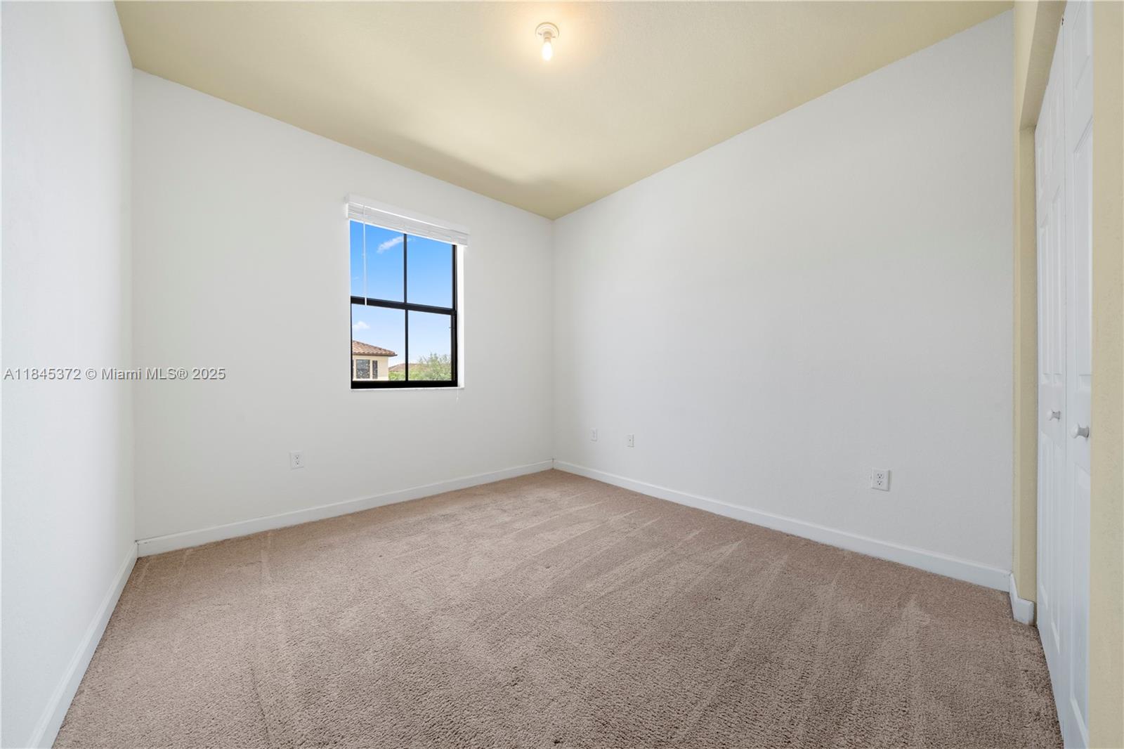 3366 West 90th Terrace, Unit 3366 Hialeah, FL 33018 - Photo 15 of 26 an empty room with windows