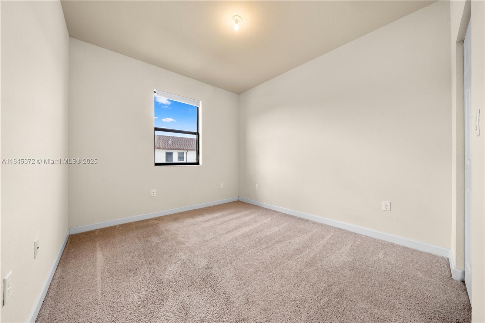 3366 West 90th Terrace, Unit 3366 Hialeah, FL 33018 - Photo 19 of 26 an empty room with windows