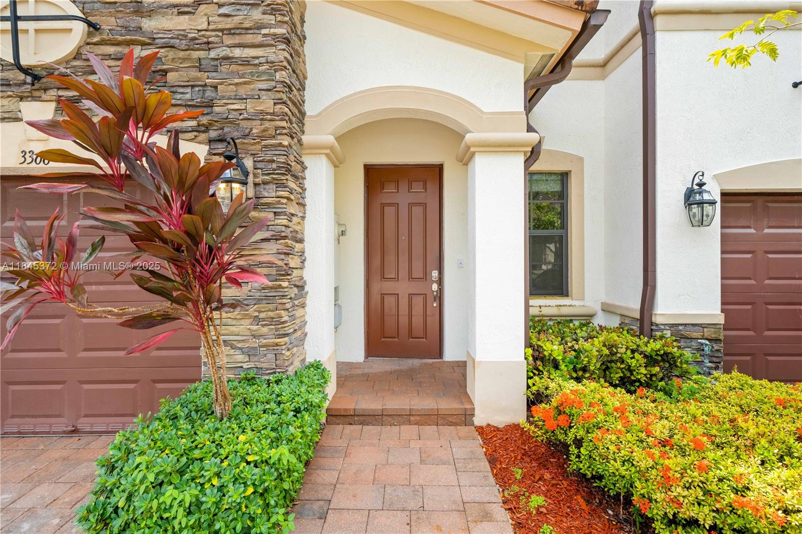 3366 West 90th Terrace, Unit 3366 Hialeah, FL 33018 - Photo 2 of 26 a front view of a house with a garden