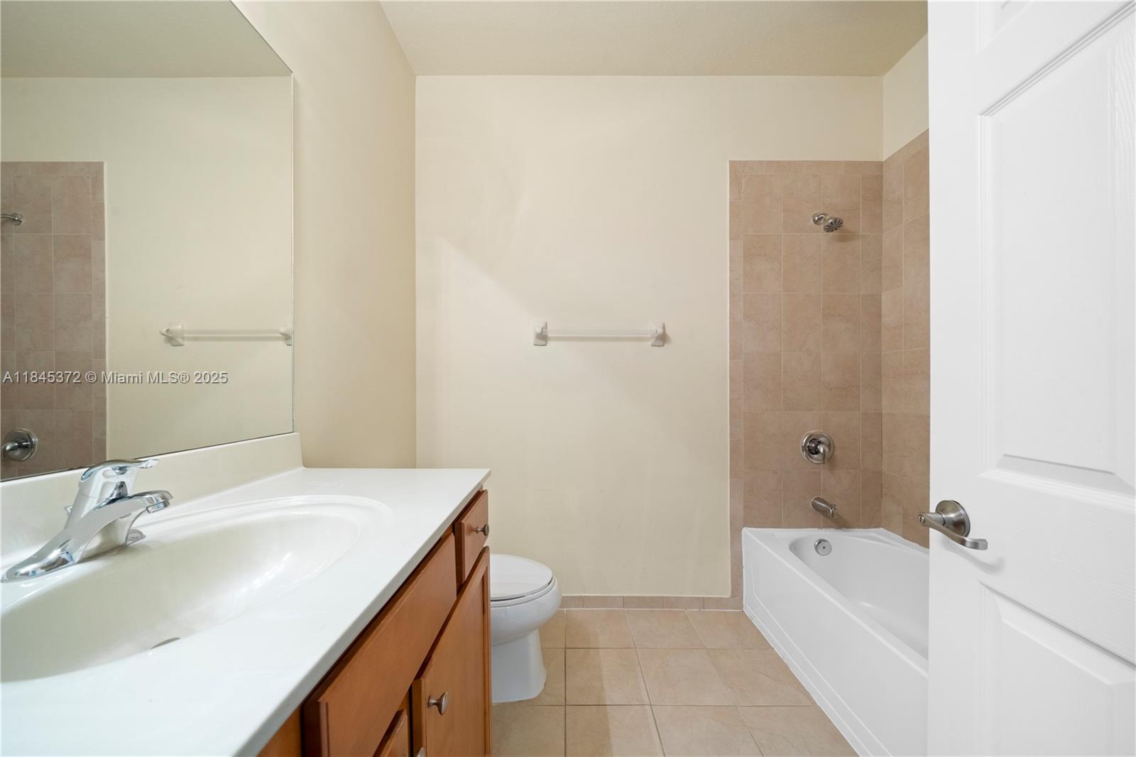 3366 West 90th Terrace, Unit 3366 Hialeah, FL 33018 - Photo 22 of 26 a bathroom with a granite countertop sink a toilet and bathtub