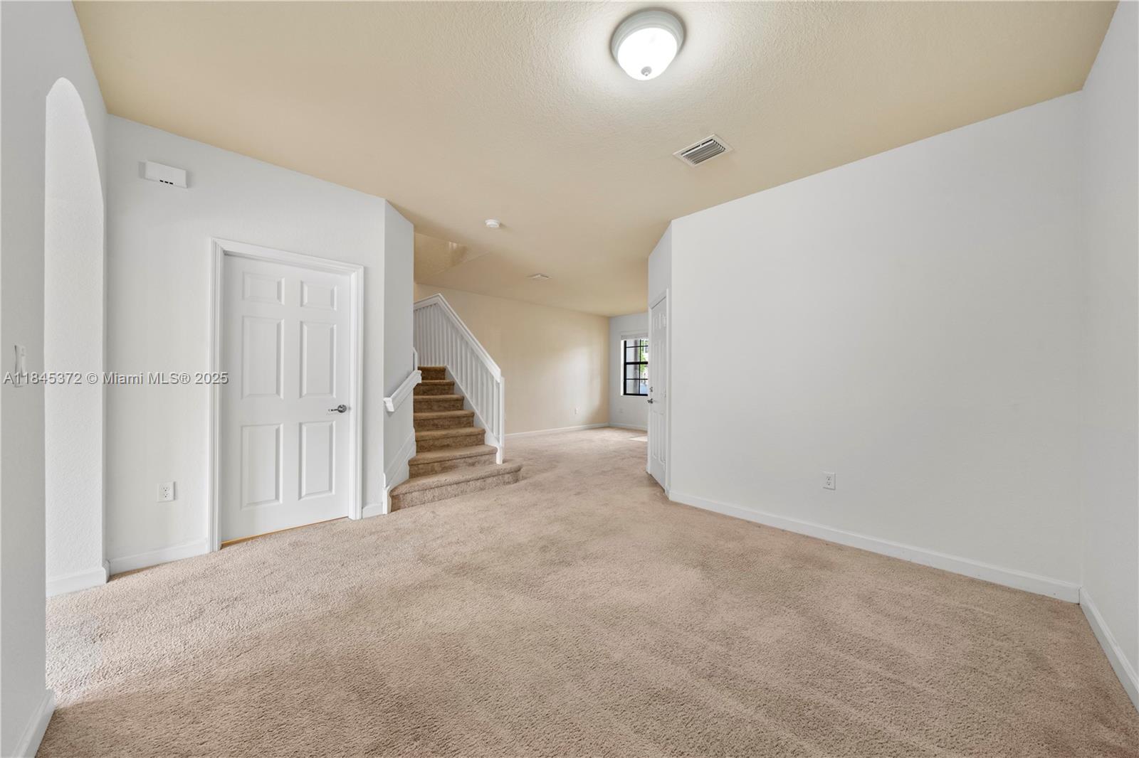 3366 West 90th Terrace, Unit 3366 Hialeah, FL 33018 - Photo 6 of 26 a view of an empty room with stairs