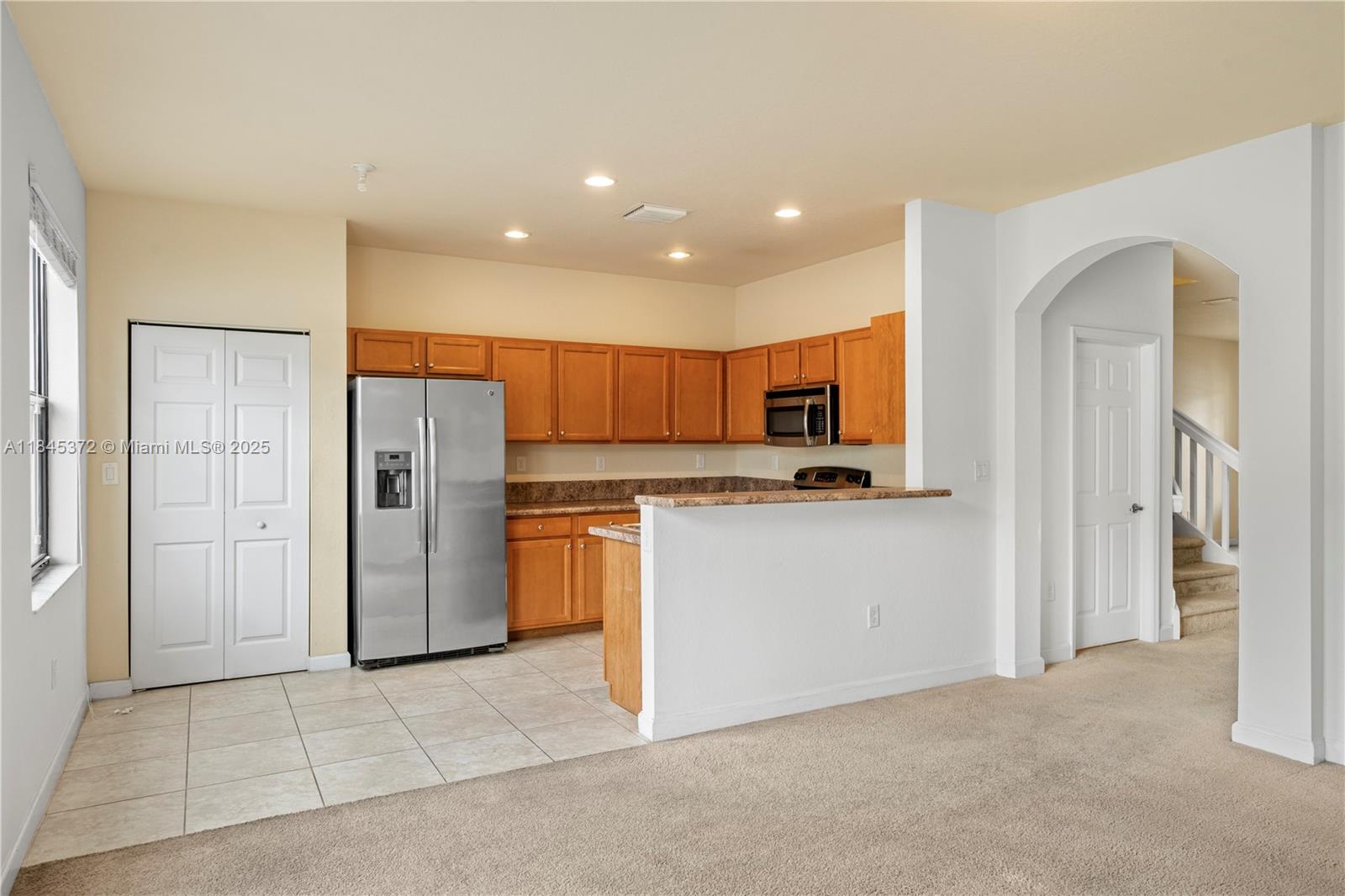 3366 West 90th Terrace, Unit 3366 Hialeah, FL 33018 - Photo 8 of 26 a kitchen with stainless steel appliances granite countertop a refrigerator and a stove top oven
