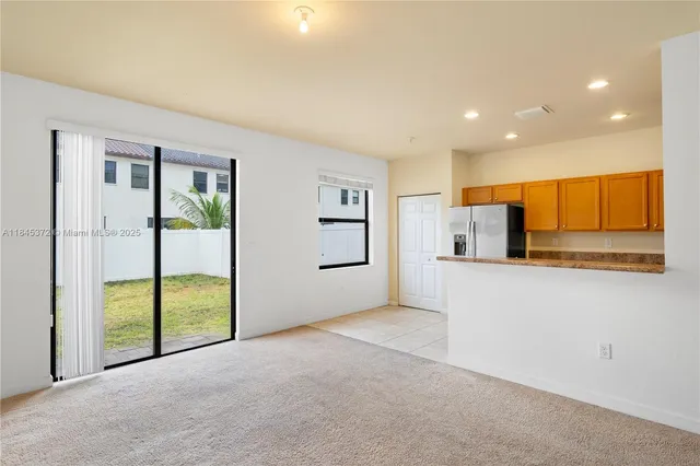 a view of a kitchen with a sink and a refrigerator