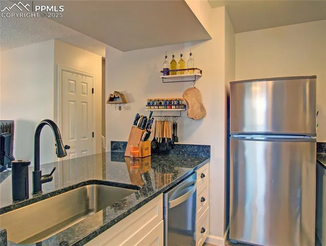 a kitchen with a refrigerator and a sink
