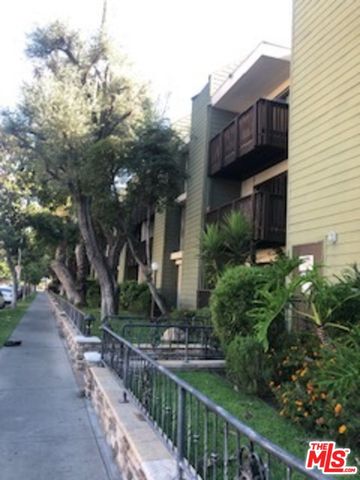 a view of a house with brick walls and flower plants