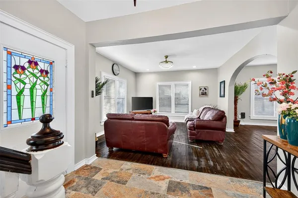 a living room with furniture a flat screen tv and a fireplace
