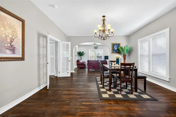 a view of a dining room with furniture wooden floor and chandelier