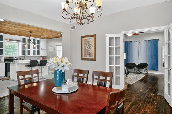 a dining room with furniture and wooden floor