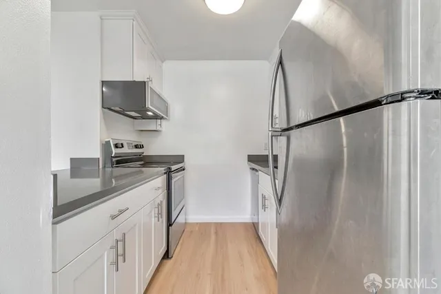 a kitchen with stainless steel appliances a sink stove and refrigerator