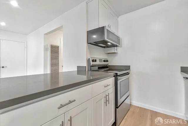 a kitchen with stainless steel appliances a sink and a stove