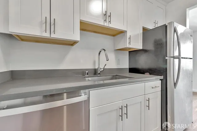 a kitchen with appliances cabinets and a sink