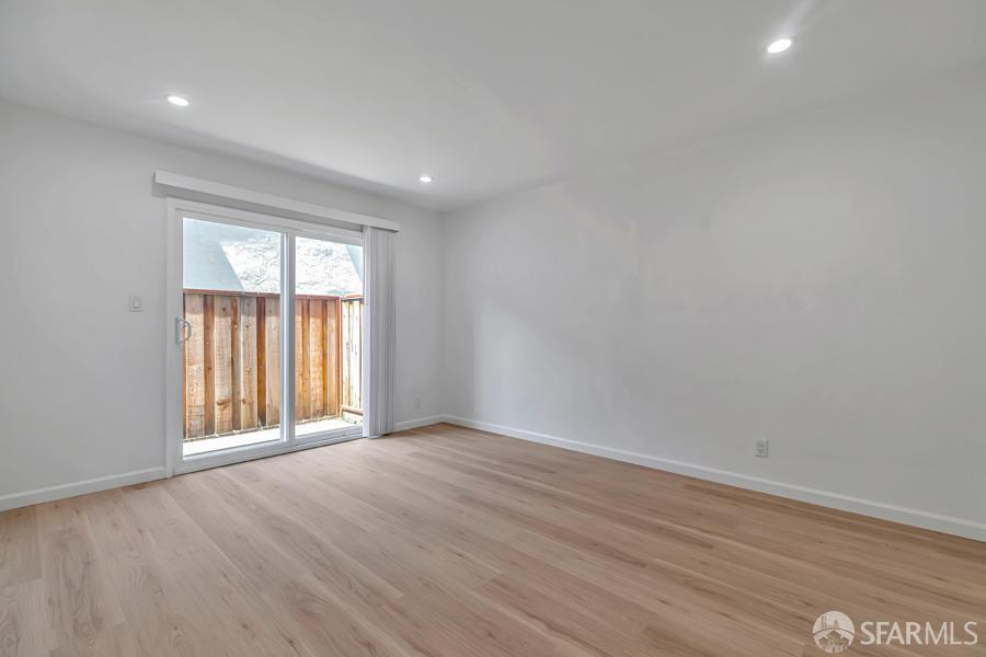 46728 Crawford Street, Unit 2 Fremont, CA 94539 - Photo 28 of 39 an empty room with wooden floor and windows