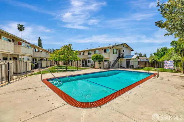 a view of a swimming pool with a patio