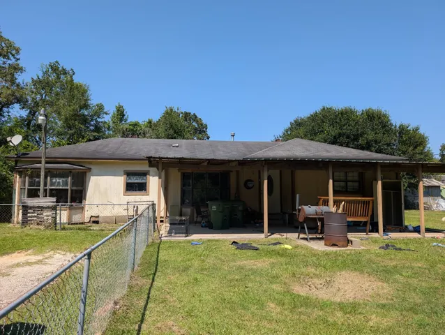a view of a house with backyard porch and furniture