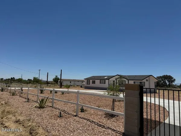 a view of swimming pool with outdoor seating and yard in back