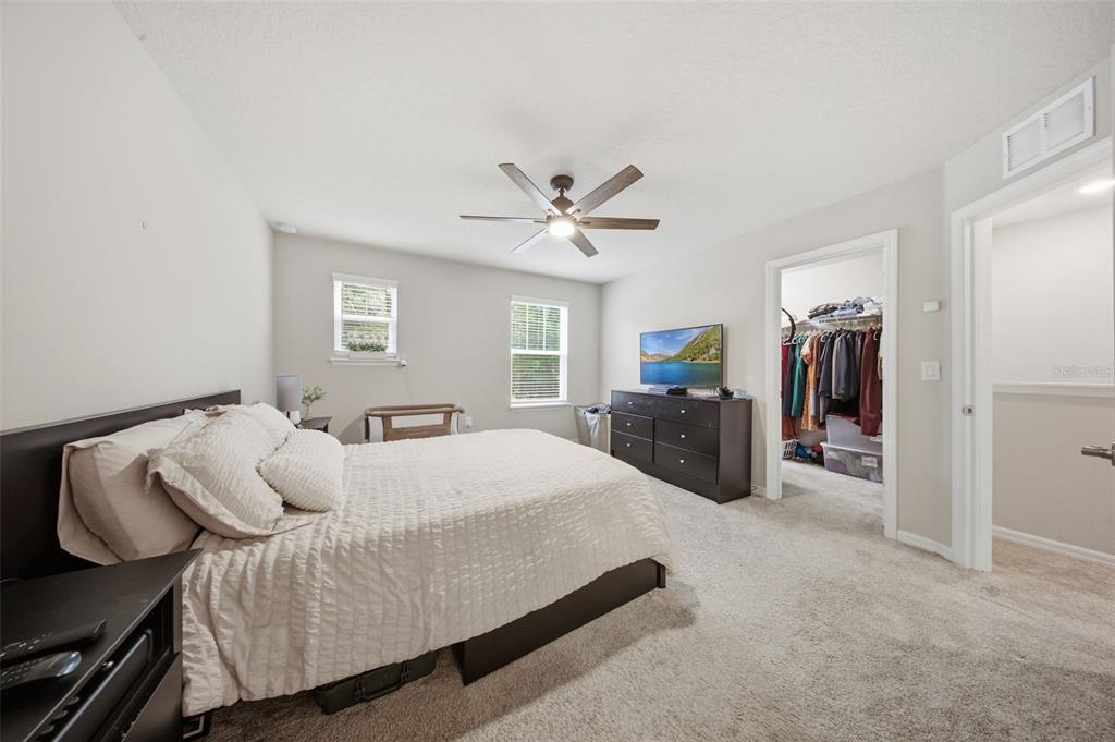 2117 Gopher Tortoise Terrace Oakland, FL 34787 - Photo 18 of 36 a bed room with a bed and a television