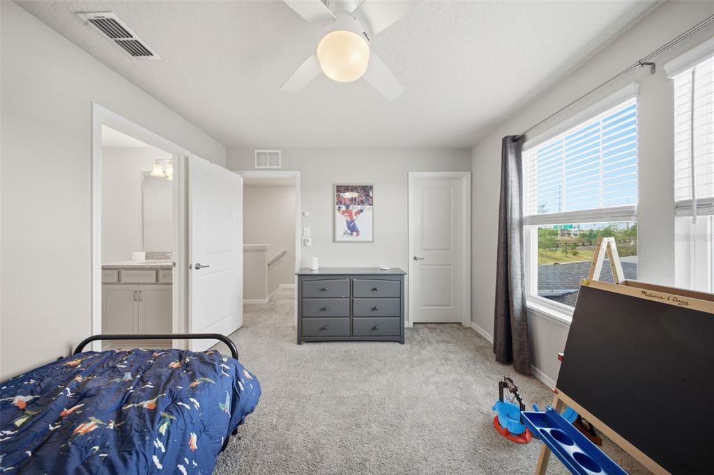 2117 Gopher Tortoise Terrace Oakland, FL 34787 - Photo 23 of 36 a bedroom with furniture and window