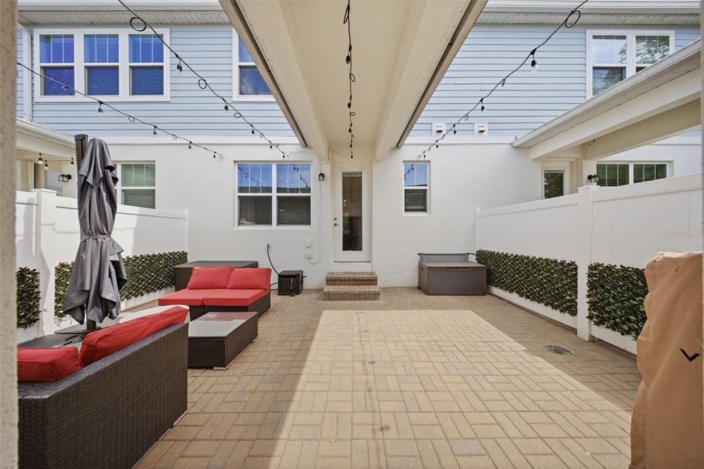 2117 Gopher Tortoise Terrace Oakland, FL 34787 - Photo 26 of 36 a view of a patio with couches chairs and potted plants
