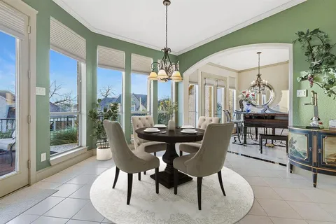 a dining room with furniture a chandelier and window