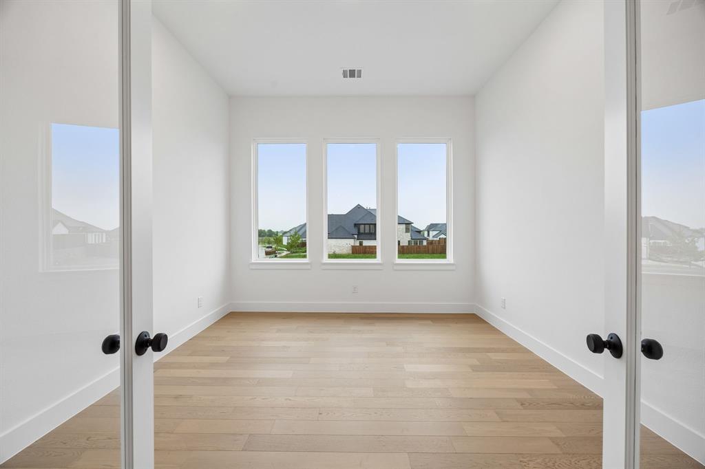 1120 Whirlabout Road Prosper, TX 75078 - Photo 4 of 25 Whether it's working from home or enjoying a good book, you will appreciate this bright and spacious home office.