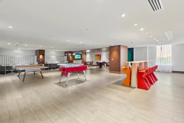 a living room with patio furniture and a potted plant