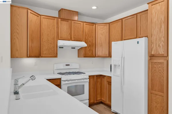 a kitchen with a refrigerator and a sink