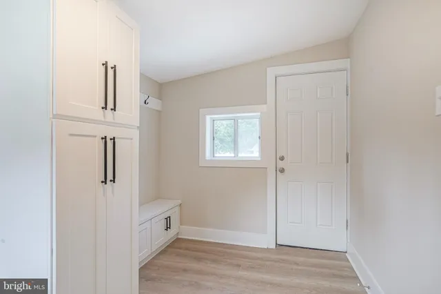 an empty room with wooden floor and closet